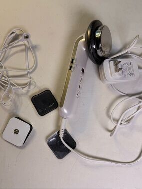 White Handheld Ultrasonic Therapy Device with Silver Head